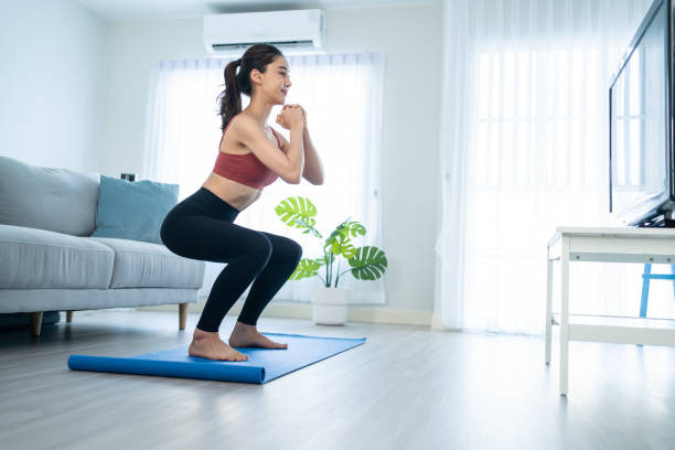 Mulher fazendo agachamento corporal em casa